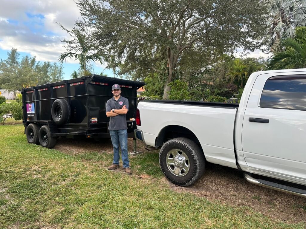 Miami Junk Patrol crew member standing in front of the truck and trailer rig in Kendall.